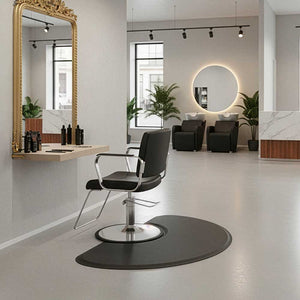 Modern salon interior with a black chair, gold-framed mirror, and decorative elements with a Semi Circle 1/2" Anti Fatigue Beauty Salon Floor Mat