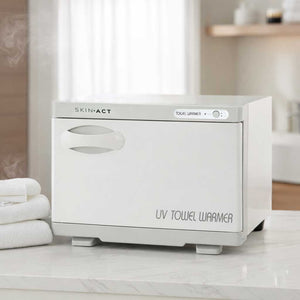 White UV 12 Piece Hot Towel Cabinet Towel Warmer With Sterilizer Plus UL on a marble surface with towels in the background