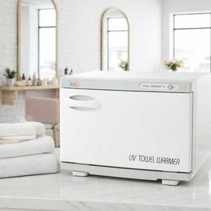 UV Skinact 24 Piece Hot Towel Cabinet With Sterilizer on a Beauty Salon counter with towels and mirrors in the background