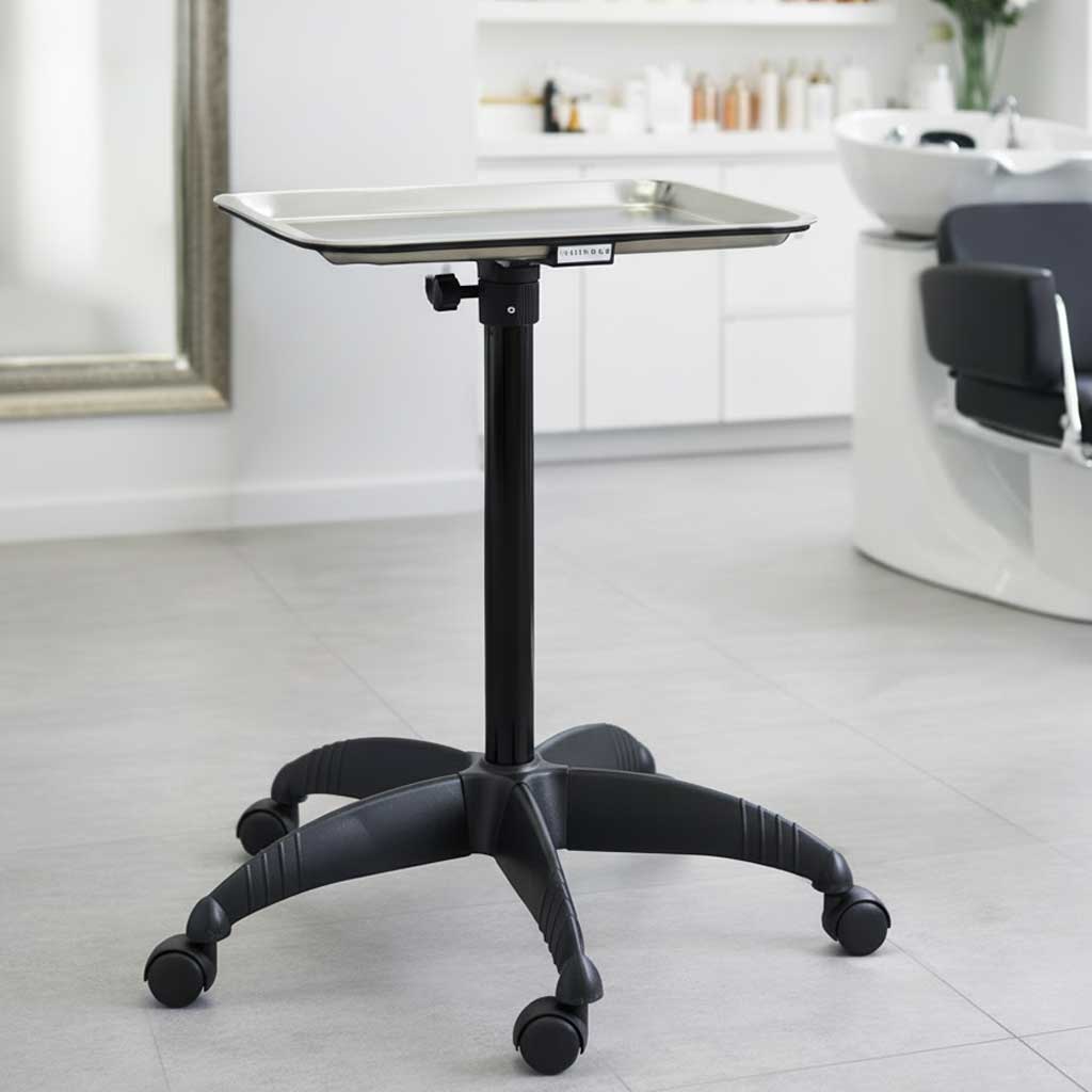 Black adjustable table on wheels in a salon setting