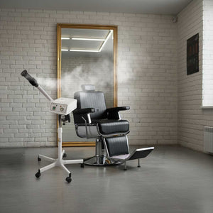 Barber chair with mirror in a room with white brick walls next to Skinact Katana Facial Steamer With Aroma Therapy